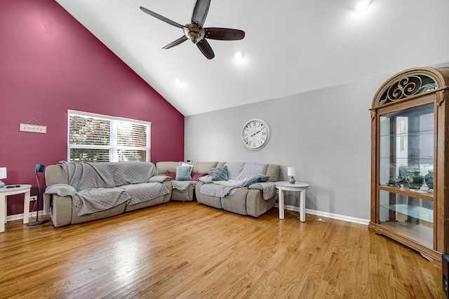 living room featuring light wood-type flooring, ceiling fan, and high vaulted ceiling