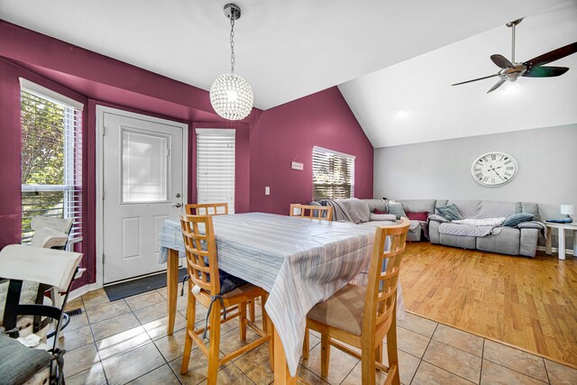 dining room featuring vaulted ceiling, ceiling fan, and light hardwood / wood-style flooring