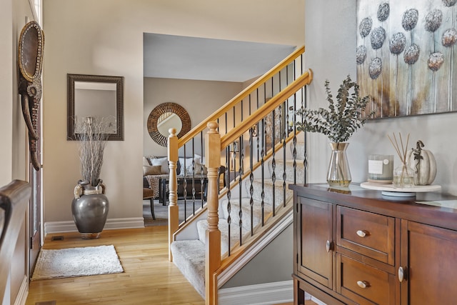 stairway featuring wood-type flooring