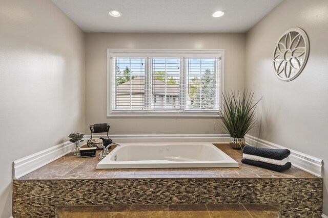 bathroom with tiled bath