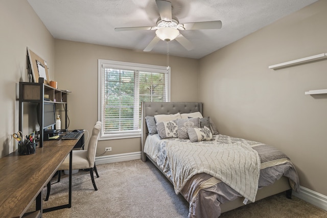 carpeted bedroom with a textured ceiling and ceiling fan