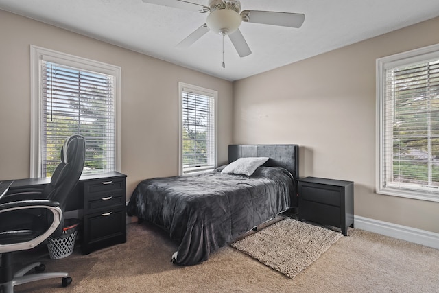 bedroom with carpet, multiple windows, and ceiling fan