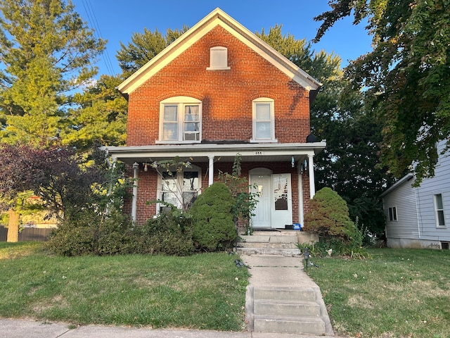 view of front of home with a porch and a front yard