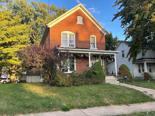 view of front facade featuring a front yard and covered porch