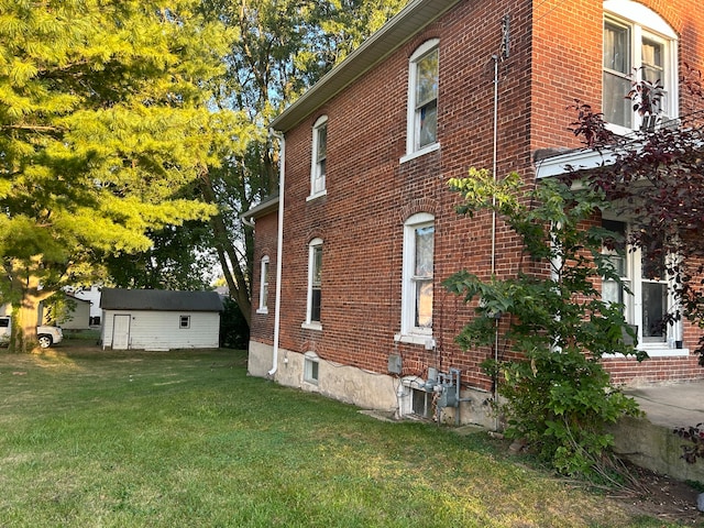 view of side of home with a lawn