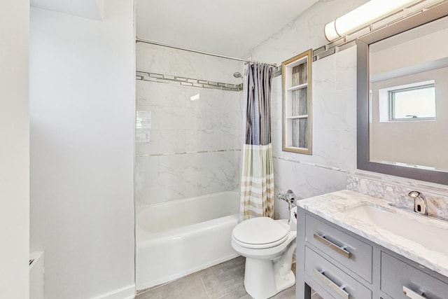 full bathroom featuring toilet, tile patterned flooring, tile walls, shower / bath combo, and vanity