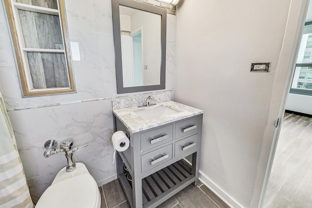 bathroom with toilet, vanity, and hardwood / wood-style flooring