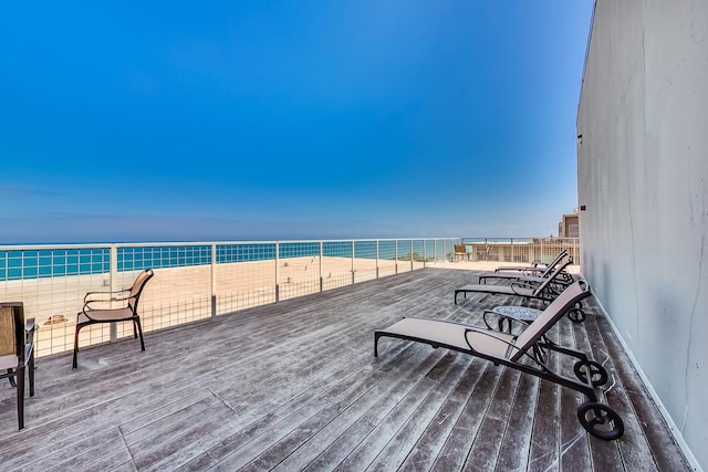 wooden deck featuring a water view