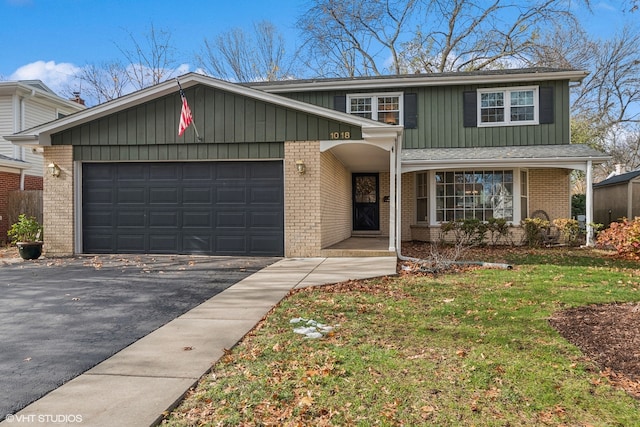 front of property with a front lawn and a garage