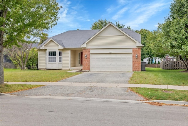 ranch-style home featuring a garage and a front lawn