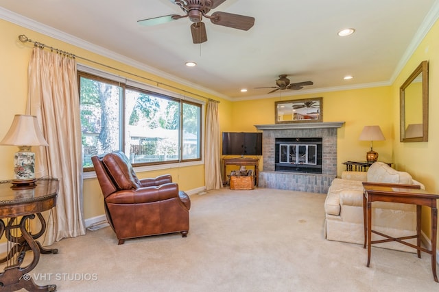 carpeted living room featuring a fireplace, ornamental molding, and ceiling fan