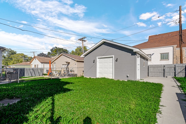 view of yard featuring a garage and an outbuilding