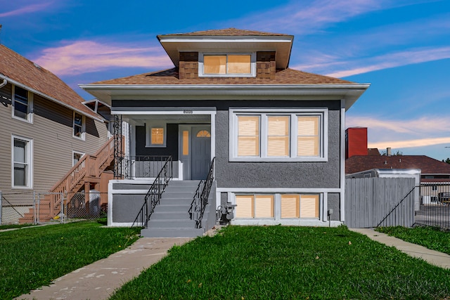 view of front facade featuring a lawn and a storage unit