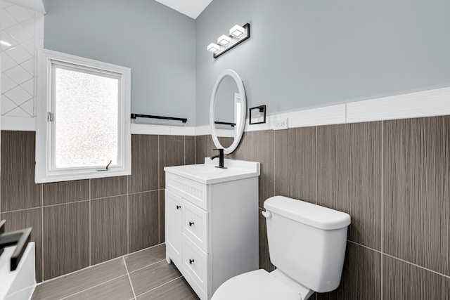 bathroom featuring tile walls, tile patterned floors, vanity, and toilet