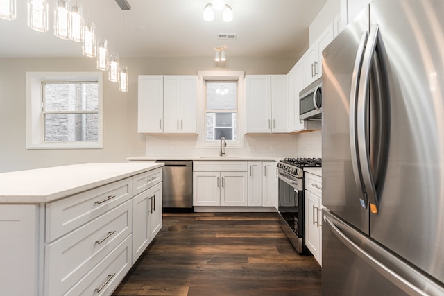 kitchen with backsplash, white cabinetry, sink, and stainless steel appliances