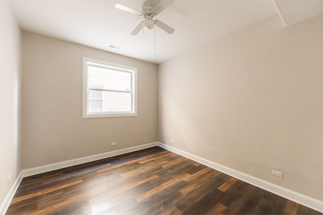 empty room with dark hardwood / wood-style floors and ceiling fan