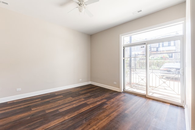 spare room featuring ceiling fan and dark hardwood / wood-style flooring