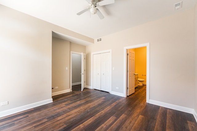 unfurnished bedroom featuring dark hardwood / wood-style flooring, ensuite bathroom, and ceiling fan