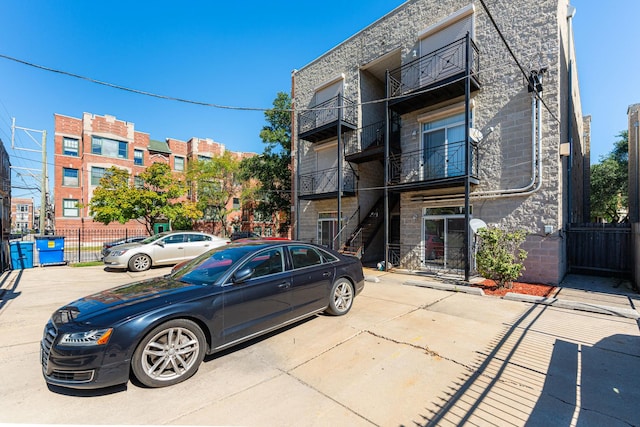 4902 S Vincennes Ave Unit 1, Chicago, IL 60615 - view of building exterior featuring fence and uncovered parking