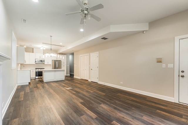 unfurnished living room with ceiling fan with notable chandelier, dark hardwood / wood-style flooring, and sink