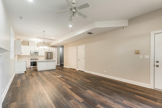 4902 S Vincennes Ave Unit 1, Chicago, IL 60615 - unfurnished living room with visible vents, a sink, dark wood-type flooring, baseboards, and ceiling fan with notable chandelier