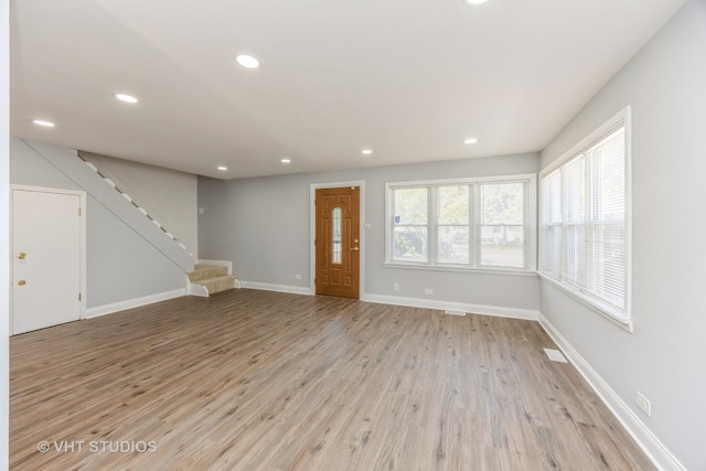 unfurnished living room with light hardwood / wood-style flooring