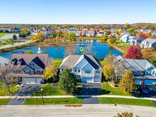 birds eye view of property featuring a water view and a residential view