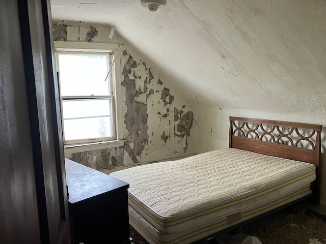 bedroom featuring lofted ceiling and multiple windows