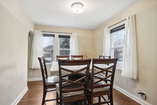 8122 W Oak Ave, Niles, IL 60714 - dining space with arched walkways, baseboards, and dark wood finished floors