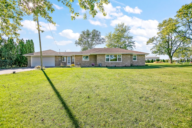 single story home with a garage and a front lawn