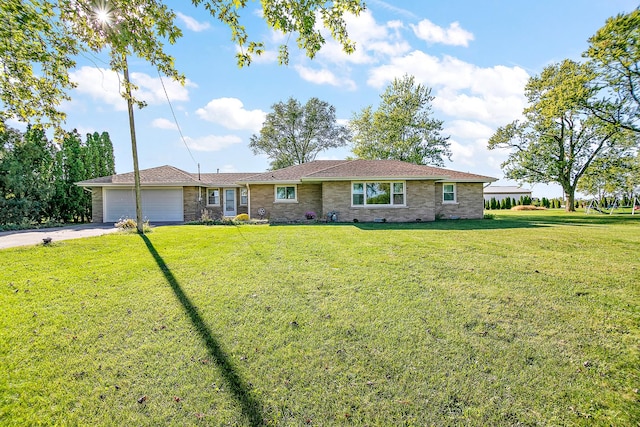 76 S 7000w Rd, Kankakee, IL 60901 - single story home with an attached garage, driveway, a front yard, and brick siding