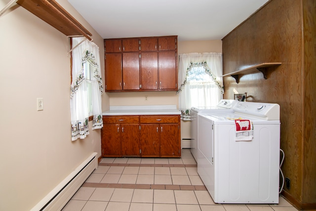 washroom featuring a baseboard radiator, light tile patterned floors, cabinets, and washer and clothes dryer