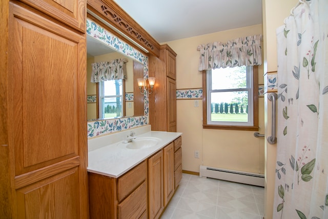 bathroom featuring a shower with shower curtain, vanity, baseboard heating, and a wealth of natural light