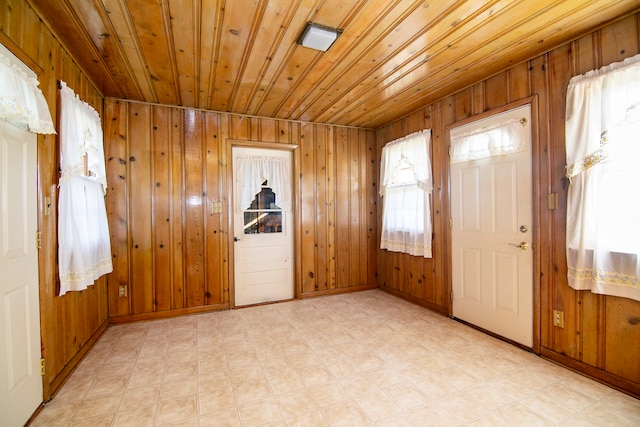 interior space featuring wood ceiling and wooden walls