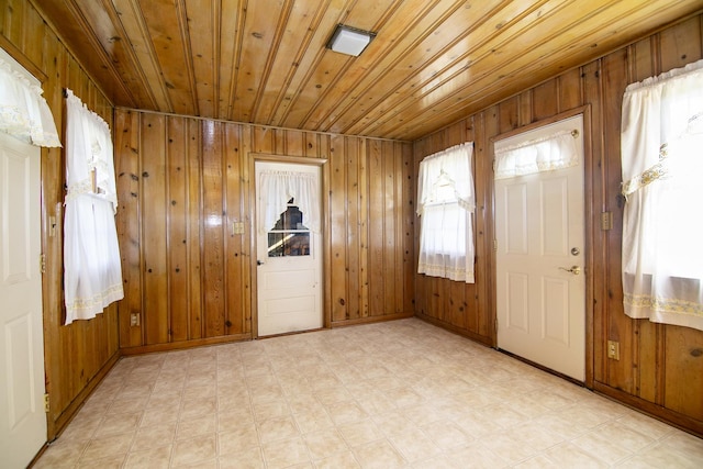 76 S 7000w Rd, Kankakee, IL 60901 - foyer entrance featuring baseboards, wood walls, light flooring, and wood ceiling