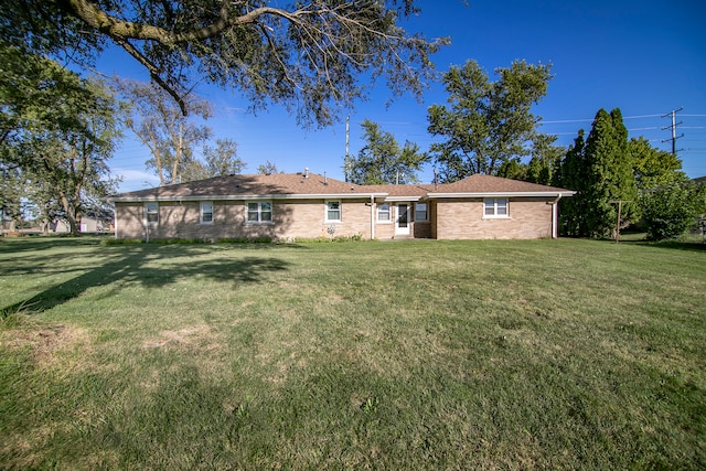 rear view of house featuring a lawn