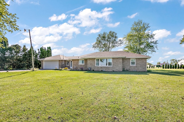 view of front of house with a front lawn and a garage