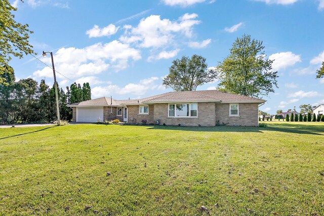76 S 7000w Rd, Kankakee, IL 60901 - ranch-style home with a garage, a front yard, and brick siding