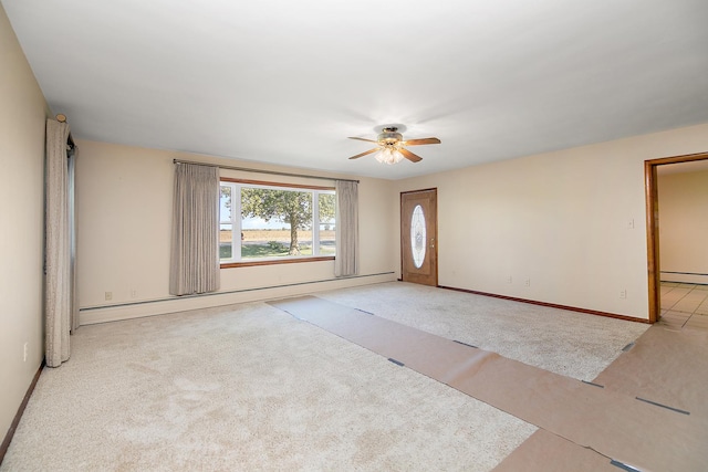 76 S 7000w Rd, Kankakee, IL 60901 - empty room featuring a ceiling fan, a baseboard radiator, baseboards, and carpet floors