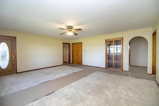 76 S 7000w Rd, Kankakee, IL 60901 - foyer entrance featuring carpet flooring, plenty of natural light, ceiling fan, and arched walkways