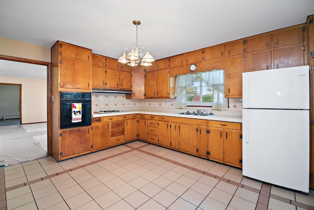 kitchen with hanging light fixtures, decorative backsplash, white appliances, sink, and a notable chandelier