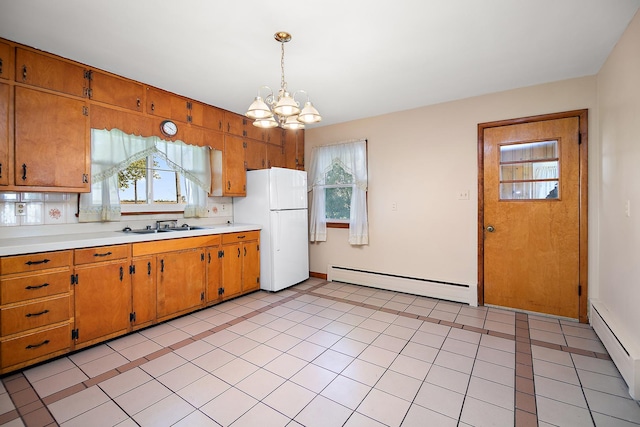 76 S 7000w Rd, Kankakee, IL 60901 - kitchen with freestanding refrigerator, a baseboard radiator, light countertops, and a chandelier