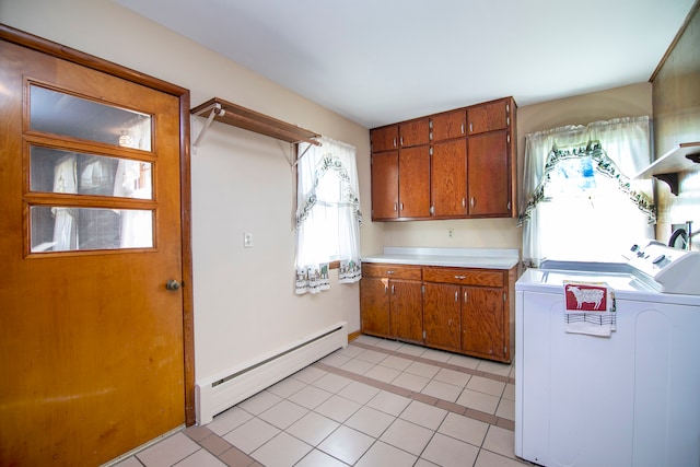 kitchen with a baseboard radiator, washing machine and clothes dryer, and light tile patterned floors