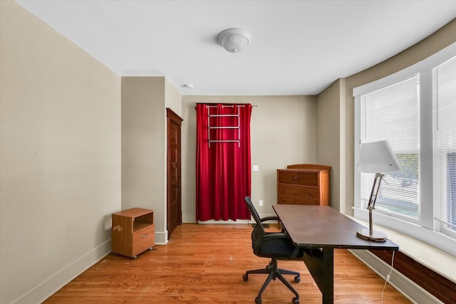 office with light wood-type flooring