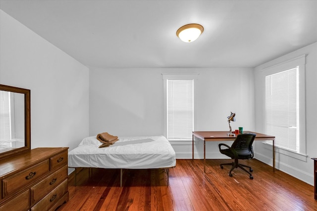 bedroom with wood-type flooring