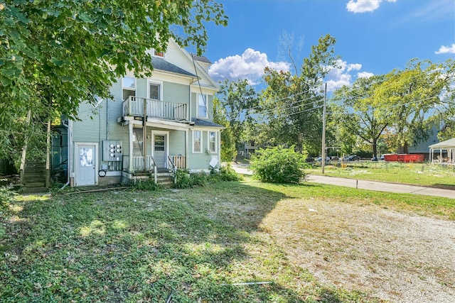 exterior space with a balcony and a front lawn