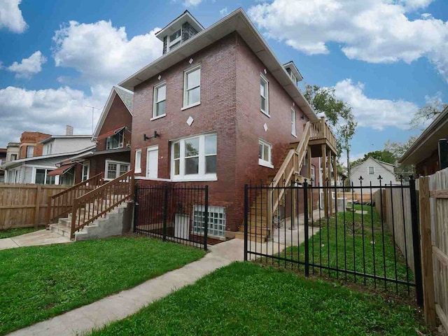 rear view of property with a yard