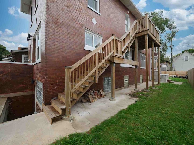 rear view of house with a lawn and a patio area