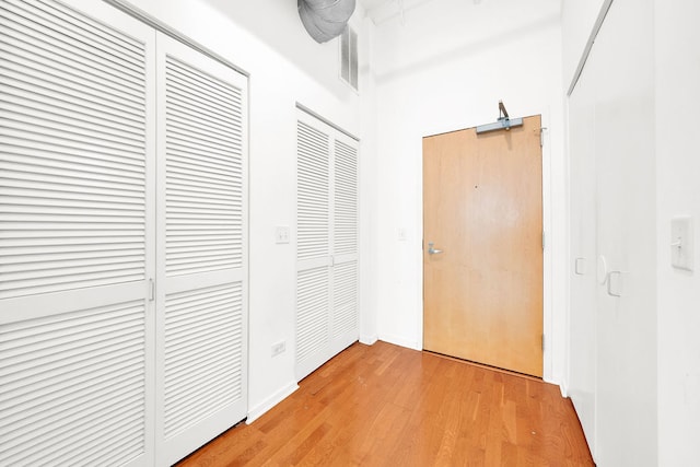 corridor with light hardwood / wood-style flooring