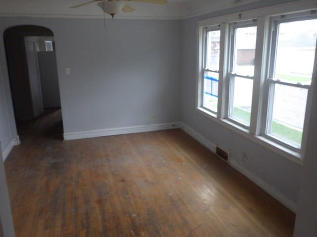 empty room featuring ceiling fan and dark hardwood / wood-style flooring